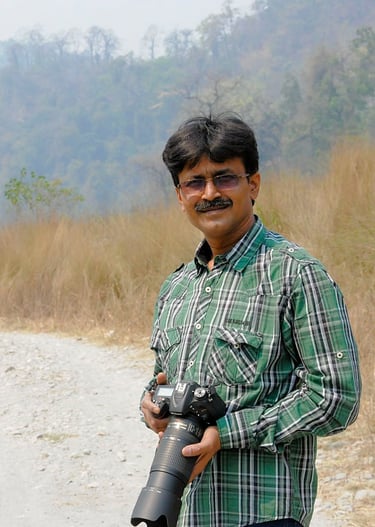 The cameraman is standing with his camera looking towards the front.