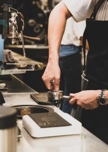 a barista making coffee