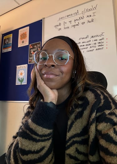 picture of Lisa Danso-Obeng from LDO Counselling in front of a board with affirmations and prompts