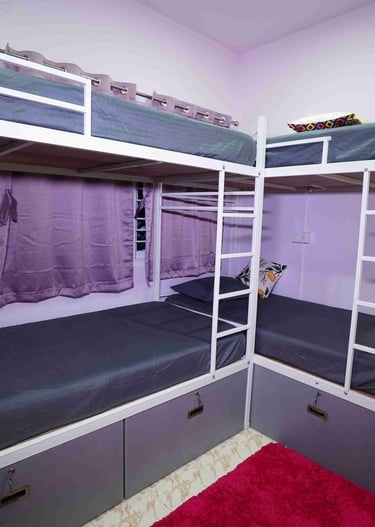 Two bunk beds and a dark pink rug