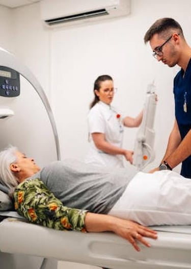 Doctor assisting a patient inside a modern MRI scanner at a diagnostic center in Delhi.