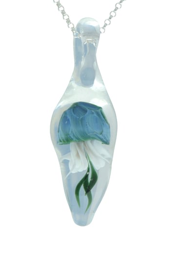 a blue jellyfish inside a clear glass pendant