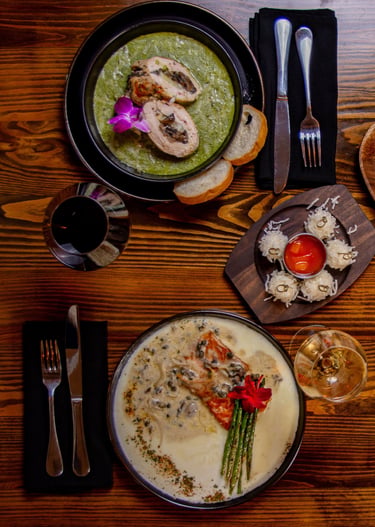 Gourmet peach dessert with fresh mint, crumble, and caramel drizzle on a wooden board.