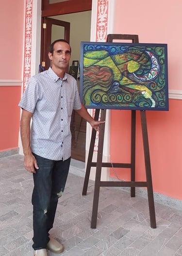 The artist standing in front of a painting