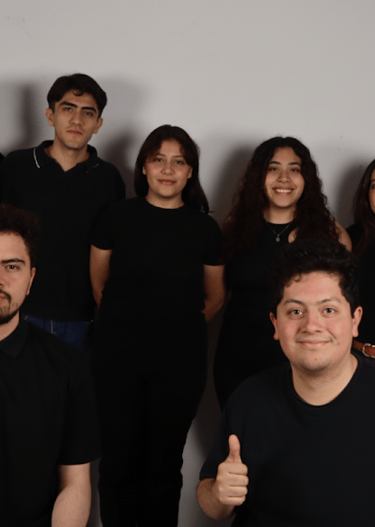 a group of people standing in front of a wall