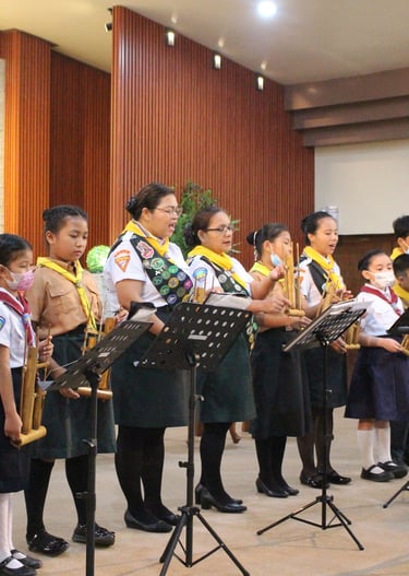 Female scouts speaking on a stage