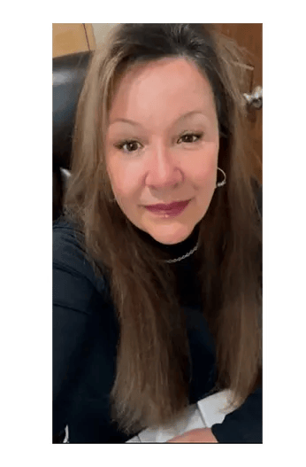 Pam, ethical AKC Chihuahua breeder in Louisiana, seated and smiling—owner of Guys Cajun Paws