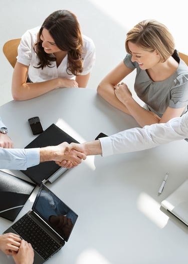 a group of business people shaking hands