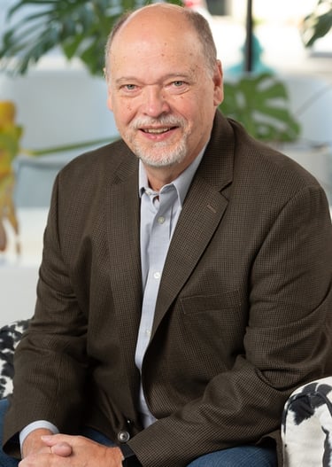 a man in a suit and tie smiling