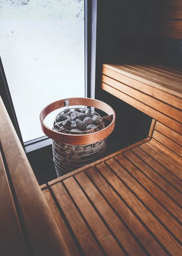 Cedar sauna interior with benches and warm window light in an Outdoor sauna Ontario design