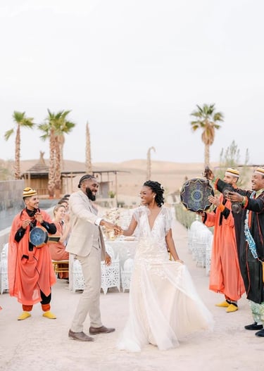 a bride and groom are dancing in a desert