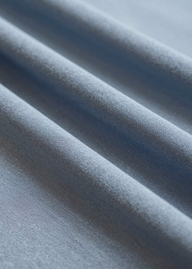 Close-up of soft fabric textures and intricate embroidery on a hijab.