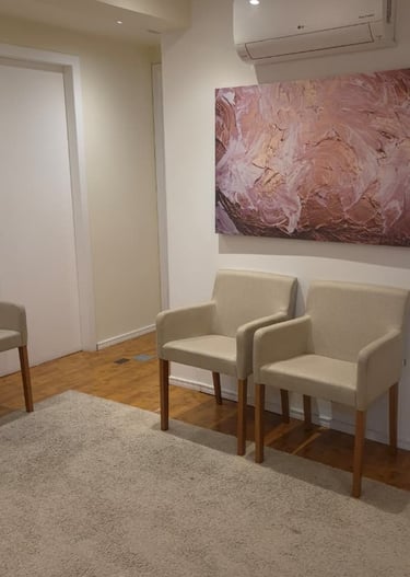 a living room with a couch and chairs