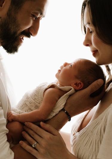 newborn looking. up at both parents, backlit natural light in Adelaide Hills studio