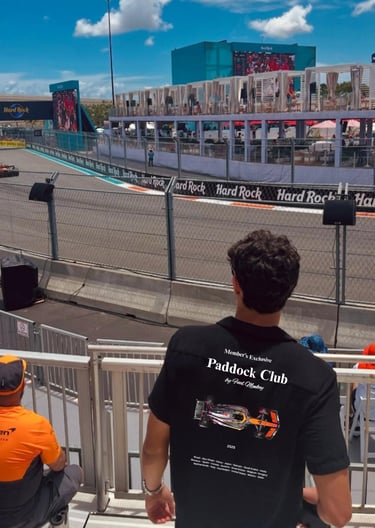 Person wearing FuelMonkey Paddock Club t-shirt watching a racing event at Hard Rock track, represent