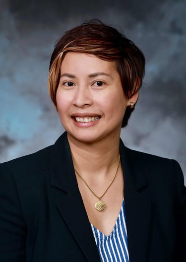 a woman in a black jacket and a blue and white striped shirt