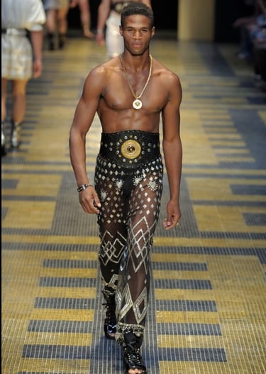 Male model on runway for donatella versace 2019 wearing Black assuit pants