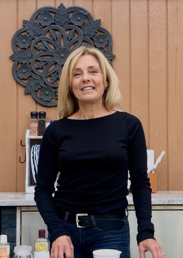 Woman standing in center of outdoor kitchen