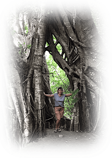 a woman standing in front of a tree