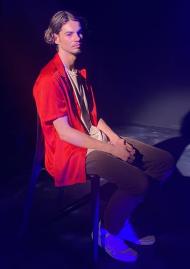 a man sitting in a chair with a guitar