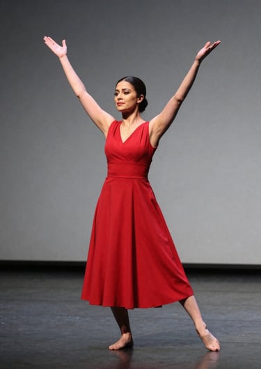 A dynamic photography of a mezzo-soprano in a red dress performing a dramatic scene on a minimalist gray stage in the United States.