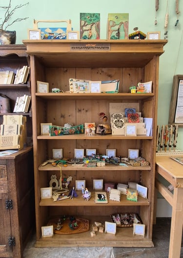 Wooden shelving with a variety of wooden products on them.