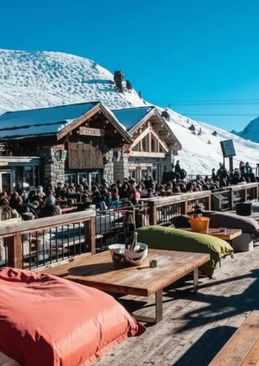 Large group après-ski celebration on a mountain terrace in Courchevel.
