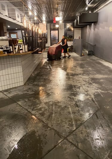 CONCRETE STAINING PROFESSIONAL WORKING IN A BUSINESS