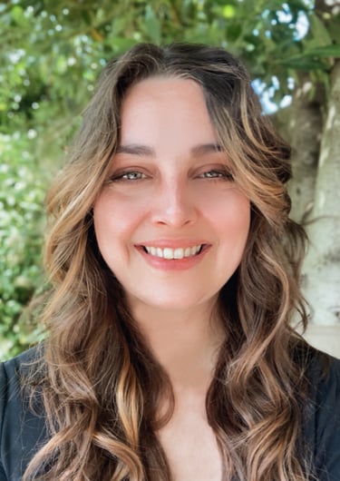 a portrait of shannon, and woman with long hair and wearing a black shirt. Tree background