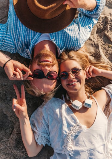 a sugar baby and a sugar mommy laying on the beach