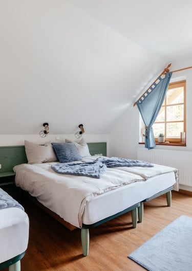 a bedroom with two beds and a chair