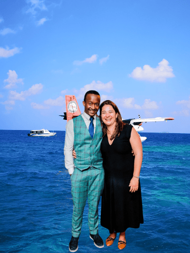a man and woman standing in front of a plane