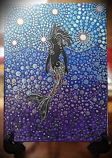 Dot painting of mermaid with tail done in crystals.