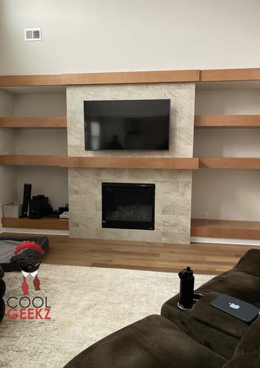 tv mounted on tile above a fireplace
