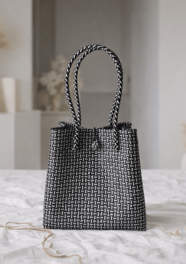 Handwoven black striped plastic tote bag handmade from recycled materials by Indonesian artisans