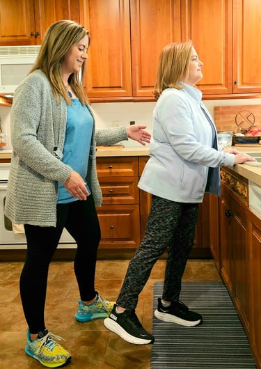 Physical therapy: teaching a patient an exercise at home.