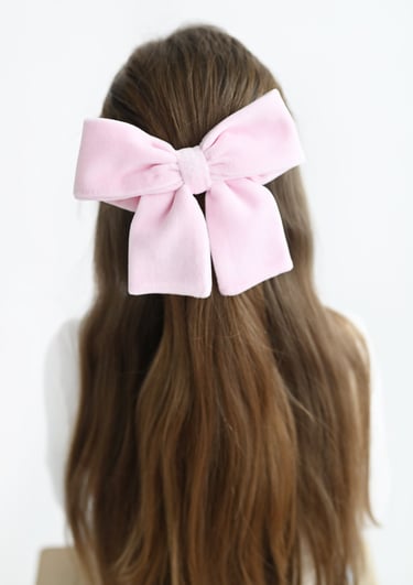 a woman with a pink bow tie on her hair
