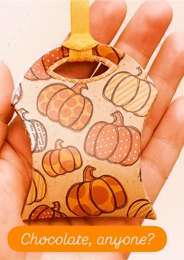 hand holding treat pouch with chocolate