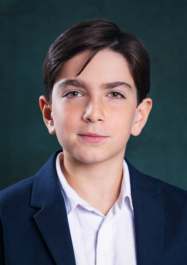 a young boy with a white shirt and a blue jacket