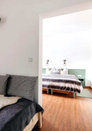 a bedroom with a bed and a bed in the middle of the room