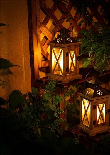two lanterns with lights on a wooden table