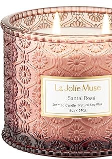 a candle with a pink candle in a glass jar