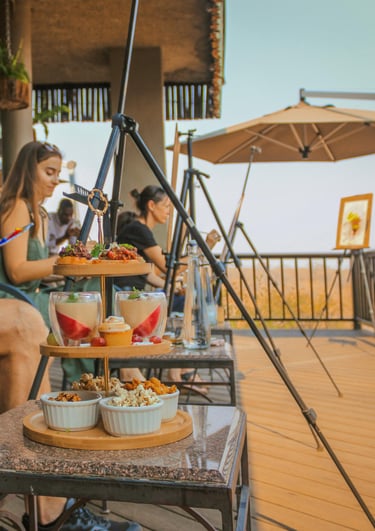 a man sitting on a table with food and drinks