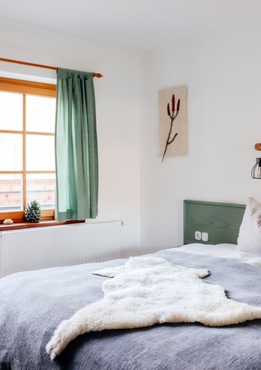 a bed with a white bed and a window