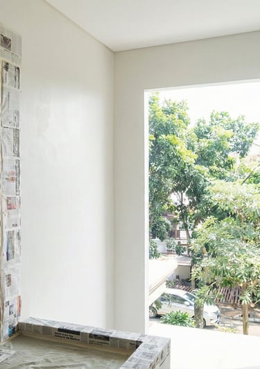 a man is painting a wall with newspaper paper