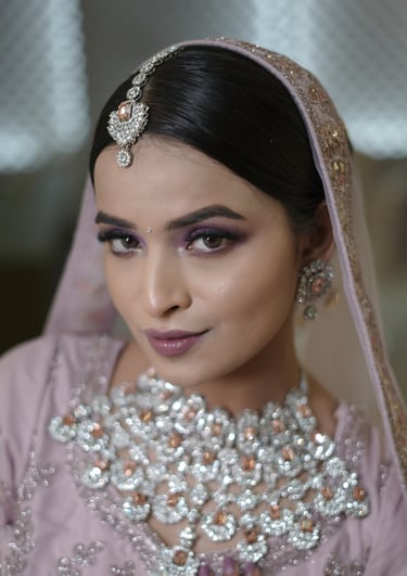 Indian bride-to-be in pastel lavender outfit with soft glam engagement makeup, shimmer eyes, gemston