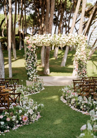 Wedding ceremony setup at Villa El Rincon with floral arch and garden seating