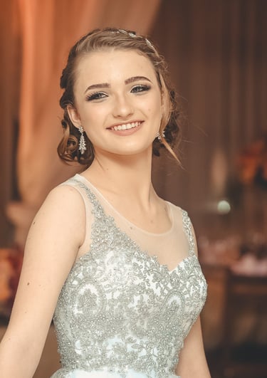 a woman in a dress standing next to a large cake