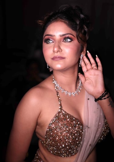 Indian woman with glam party makeup, smokey eyes, glowing skin, shimmering embellished blouse, and s