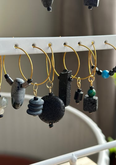 Rosevale Accessories handmade gemstone wine charms on jewelry display